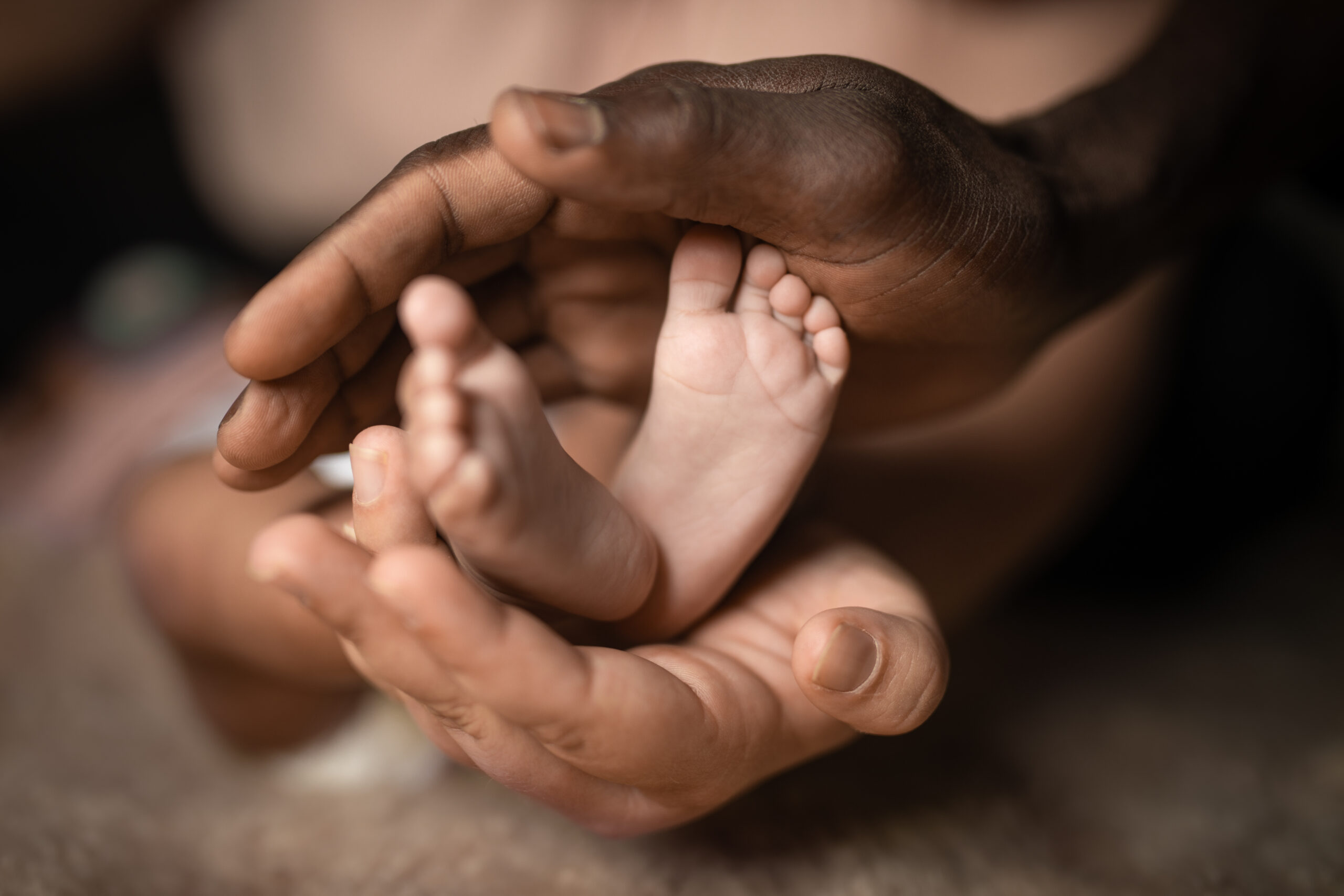 Mother holding babies feet